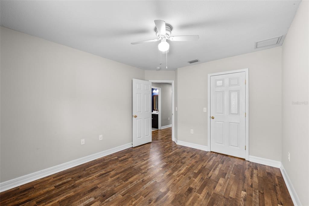 5909 Wedgefield Drive Zephyrhills, FL 33541 - Photo 41 of 54 a view of an empty room with wooden floor