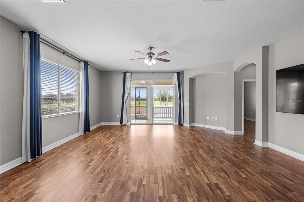 5909 Wedgefield Drive Zephyrhills, FL 33541 - Photo 45 of 54 a view of an empty room with wooden floor and a window