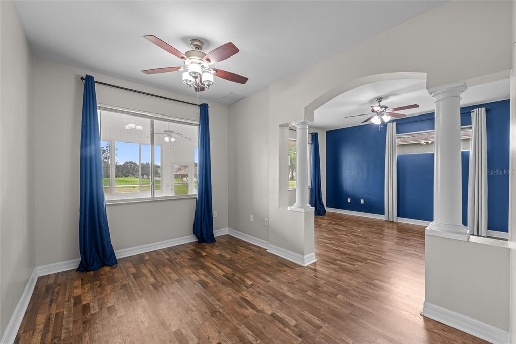 5909 Wedgefield Drive Zephyrhills, FL 33541 - Photo 46 of 54 a view of livingroom with hardwood floor and ceiling fan
