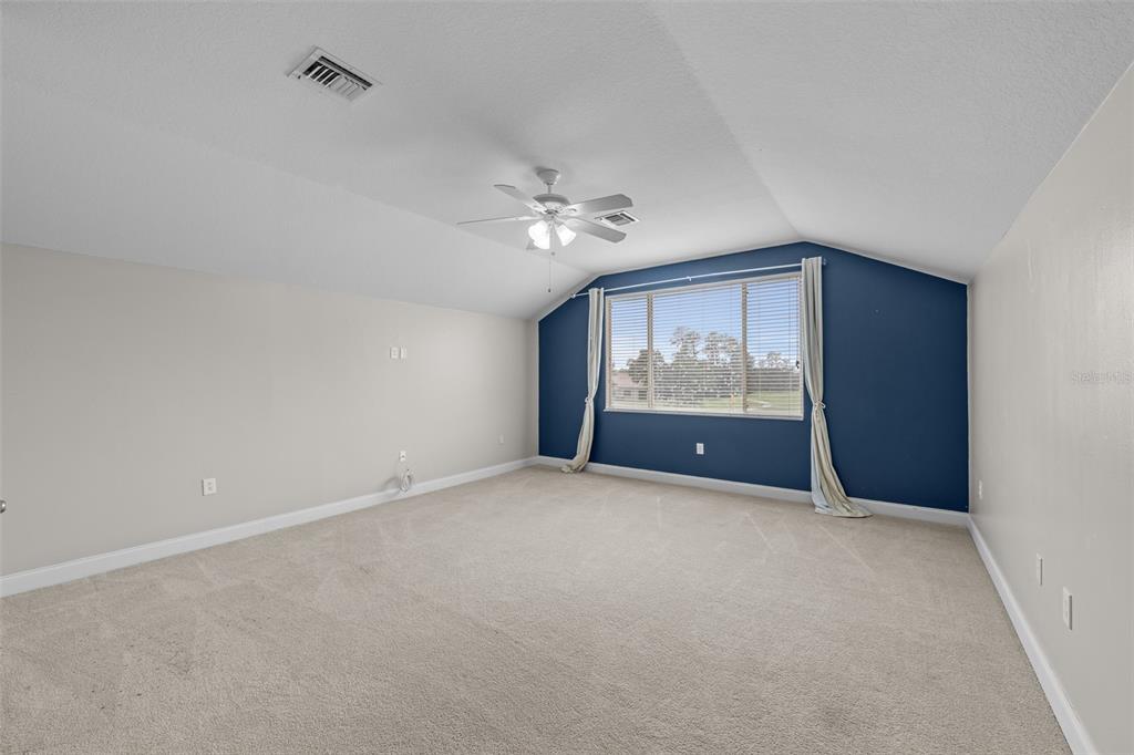 5909 Wedgefield Drive Zephyrhills, FL 33541 - Photo 52 of 54 an empty room with windows and ceiling fan