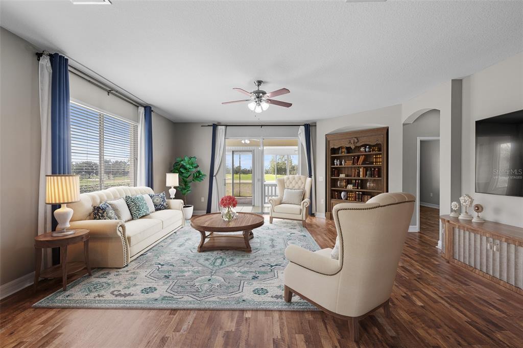 5909 Wedgefield Drive Zephyrhills, FL 33541 - Photo 6 of 54 a living room with furniture and a large window