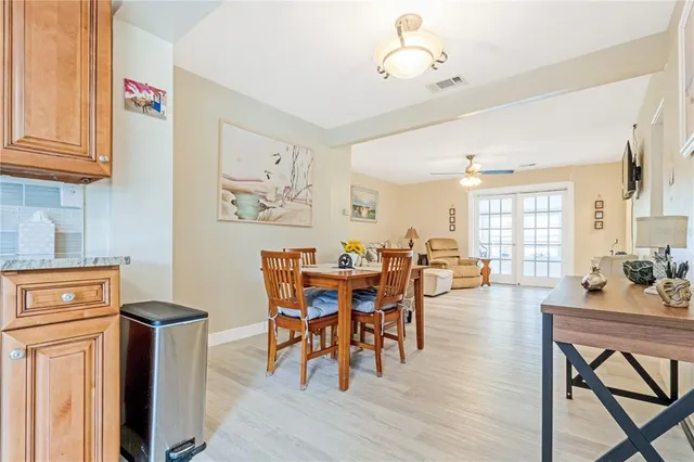 a dining room with furniture and wooden floor
