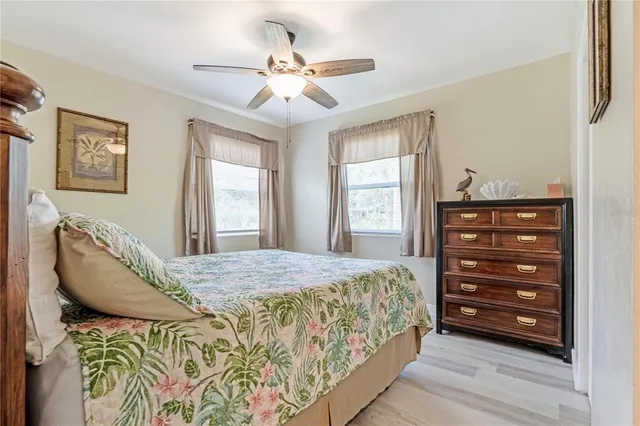 a view of a hallway with wooden floor and furniture