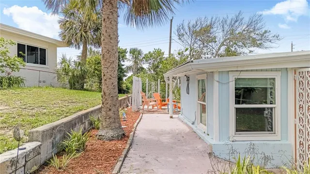 a view of a house with backyard and sitting area