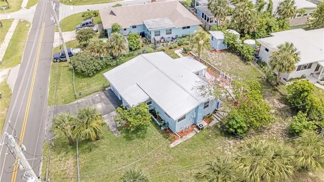 an aerial view of a house with a yard