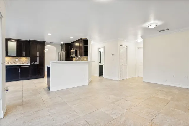 a view of kitchen with stainless steel appliances a refrigerator and a stove top oven