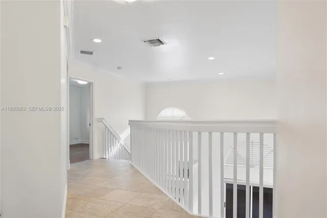 a view of an empty room with window and closet area