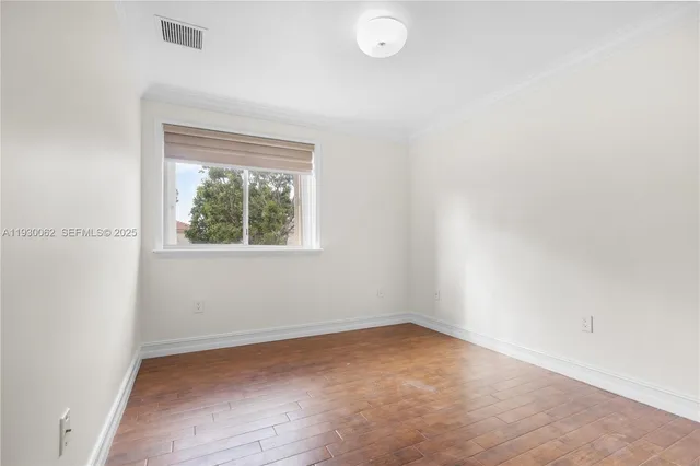 an empty room with closet and wooden floor