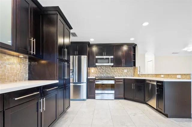 a kitchen with stainless steel appliances granite countertop a sink counter space cabinets and a window