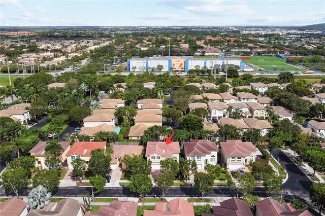an aerial view of residential houses with outdoor space
