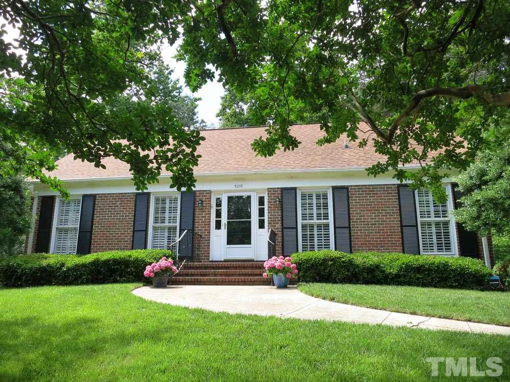 5215 Knollwood Road Raleigh, NC 27609 - Photo 1 of 30 a front view of a house with a garden and yard