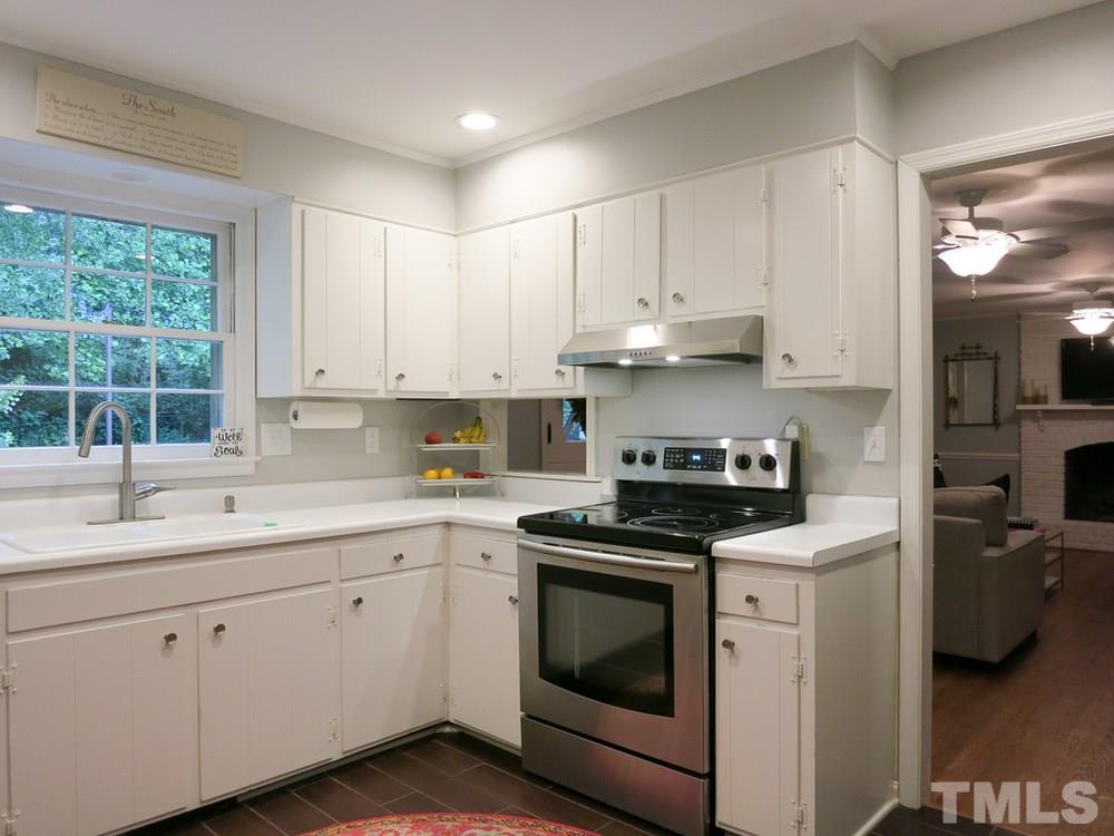 5215 Knollwood Road Raleigh, NC 27609 - Photo 11 of 30 a kitchen with cabinets appliances a sink and a window