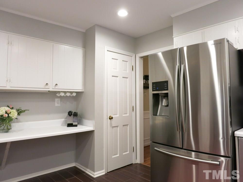 5215 Knollwood Road Raleigh, NC 27609 - Photo 12 of 30 a kitchen with stainless steel appliances a refrigerator sink and cabinets