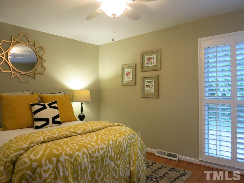 5215 Knollwood Road Raleigh, NC 27609 - Photo 18 of 30 a bed sitting in a bedroom next to a window