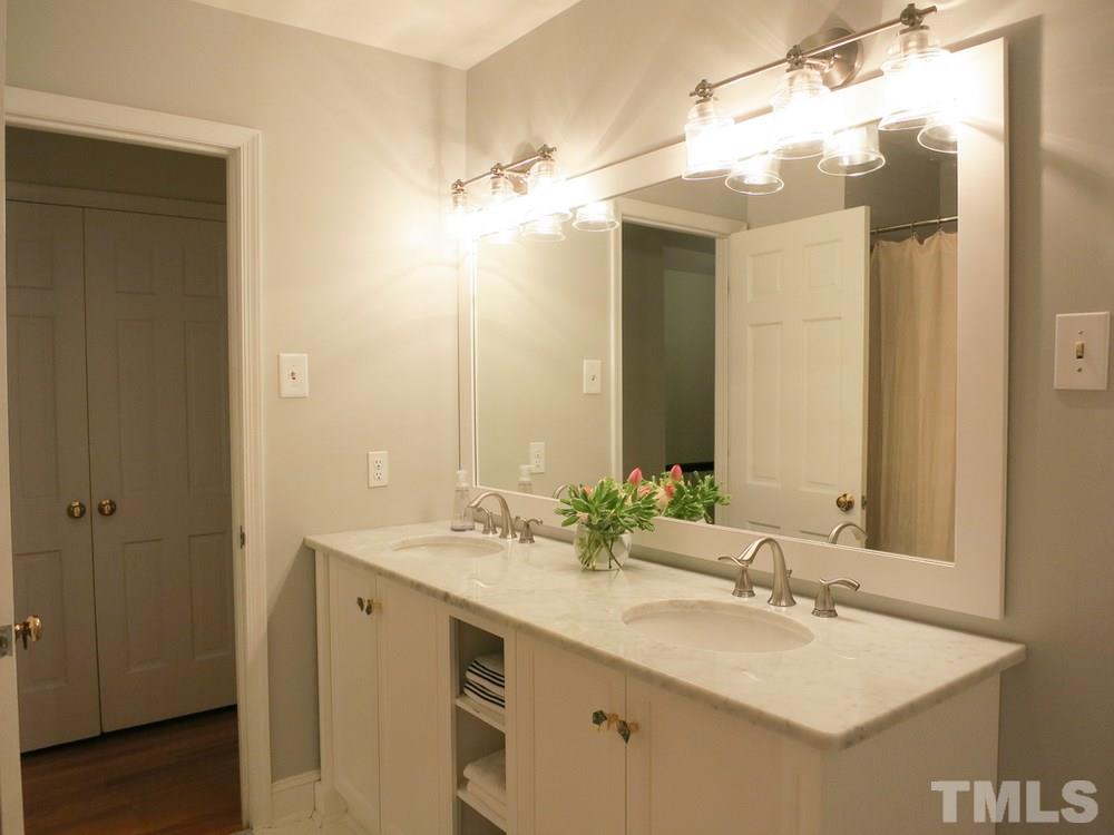 5215 Knollwood Road Raleigh, NC 27609 - Photo 23 of 30 a bathroom with a sink double vanity and a mirror