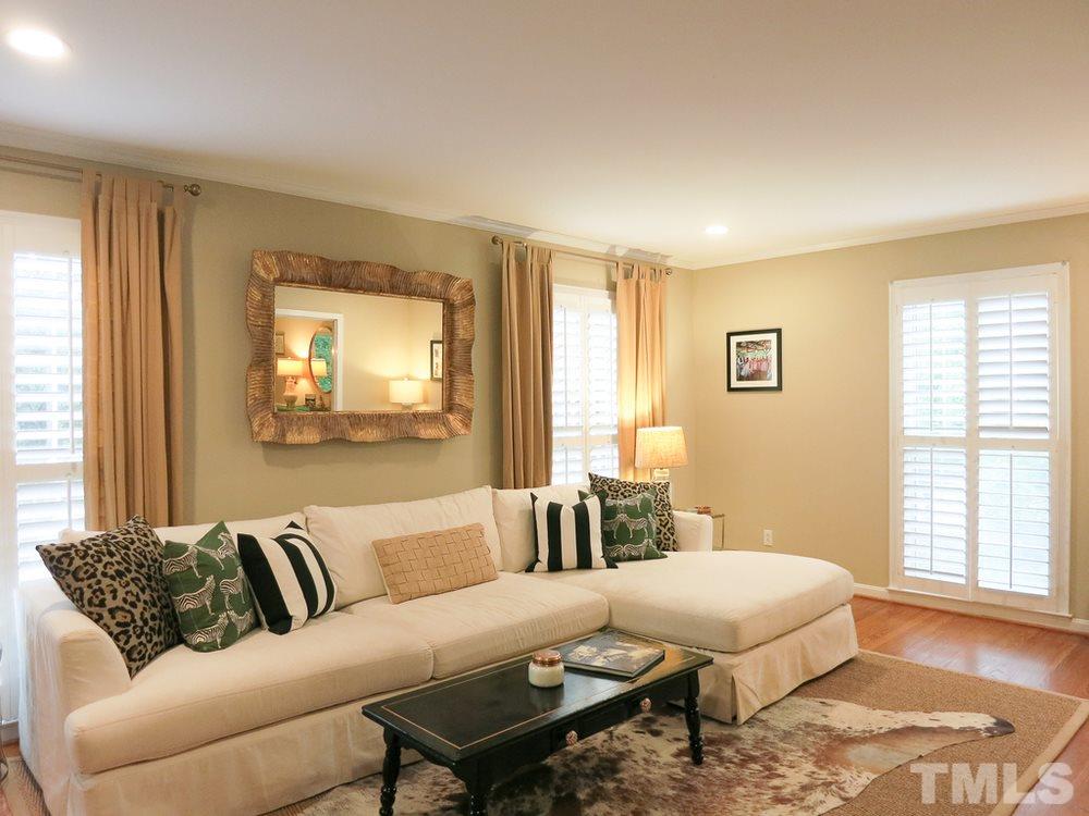 5215 Knollwood Road Raleigh, NC 27609 - Photo 5 of 30 a living room with a couch and a dresser with wooden floor