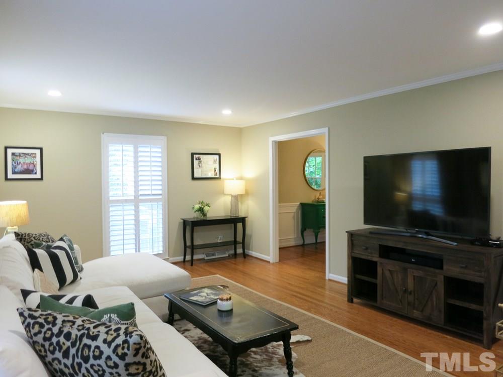 5215 Knollwood Road Raleigh, NC 27609 - Photo 6 of 30 a living room with furniture and a flat screen tv