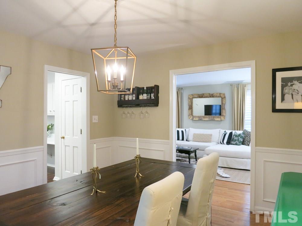 5215 Knollwood Road Raleigh, NC 27609 - Photo 9 of 30 a living room with furniture and a chandelier