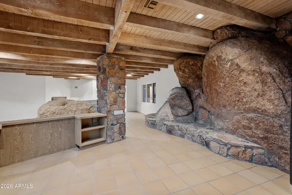 a kitchen with granite countertop a refrigerator and a stove top oven
