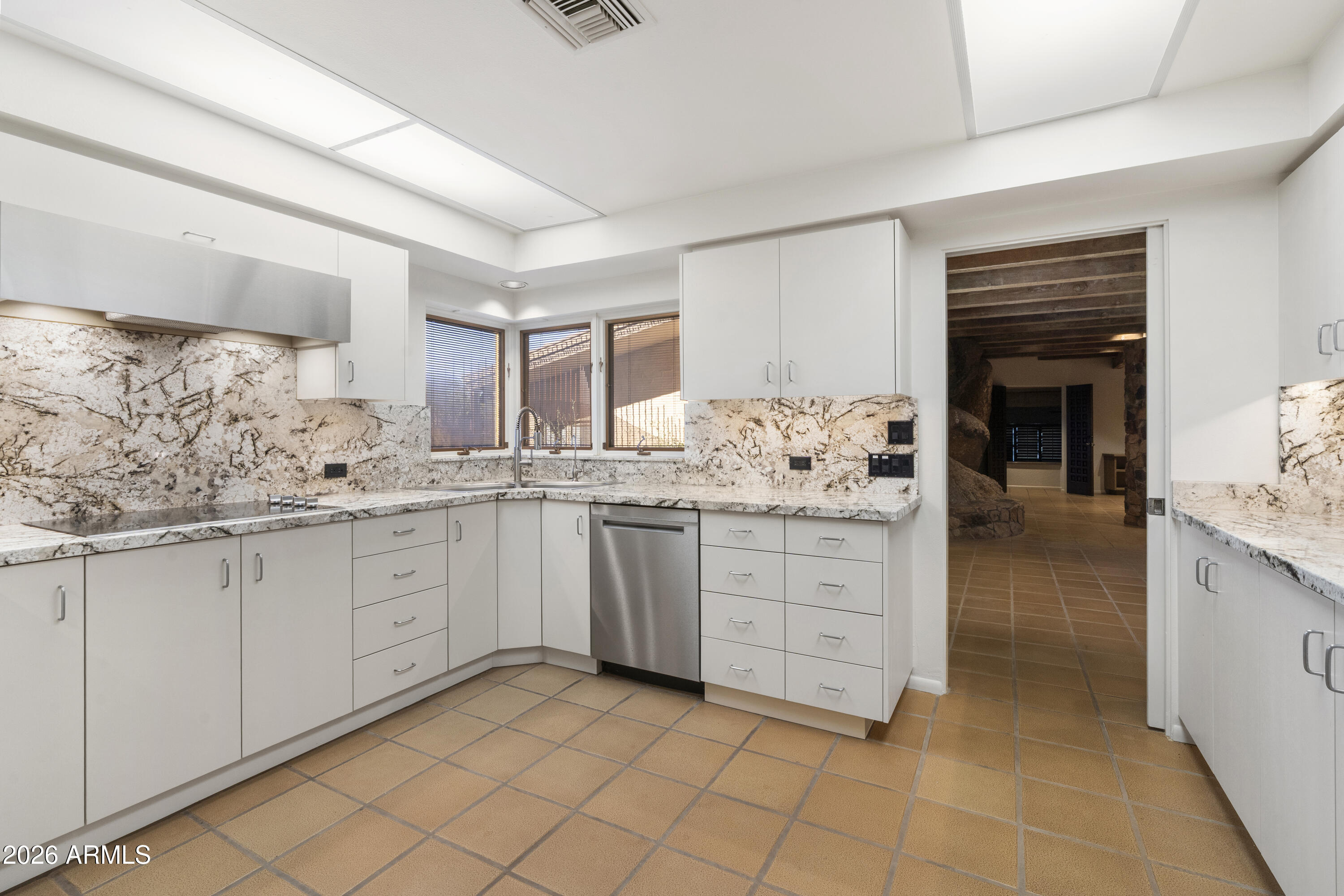 6700 East Hawksnest Road Carefree, AZ 85377 - Photo 20 of 82 a kitchen with granite countertop cabinets and white stainless steel appliances