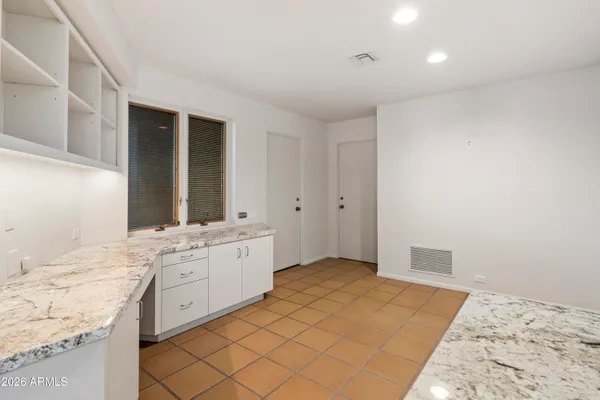 a large bathroom with a large mirror vanity and shower