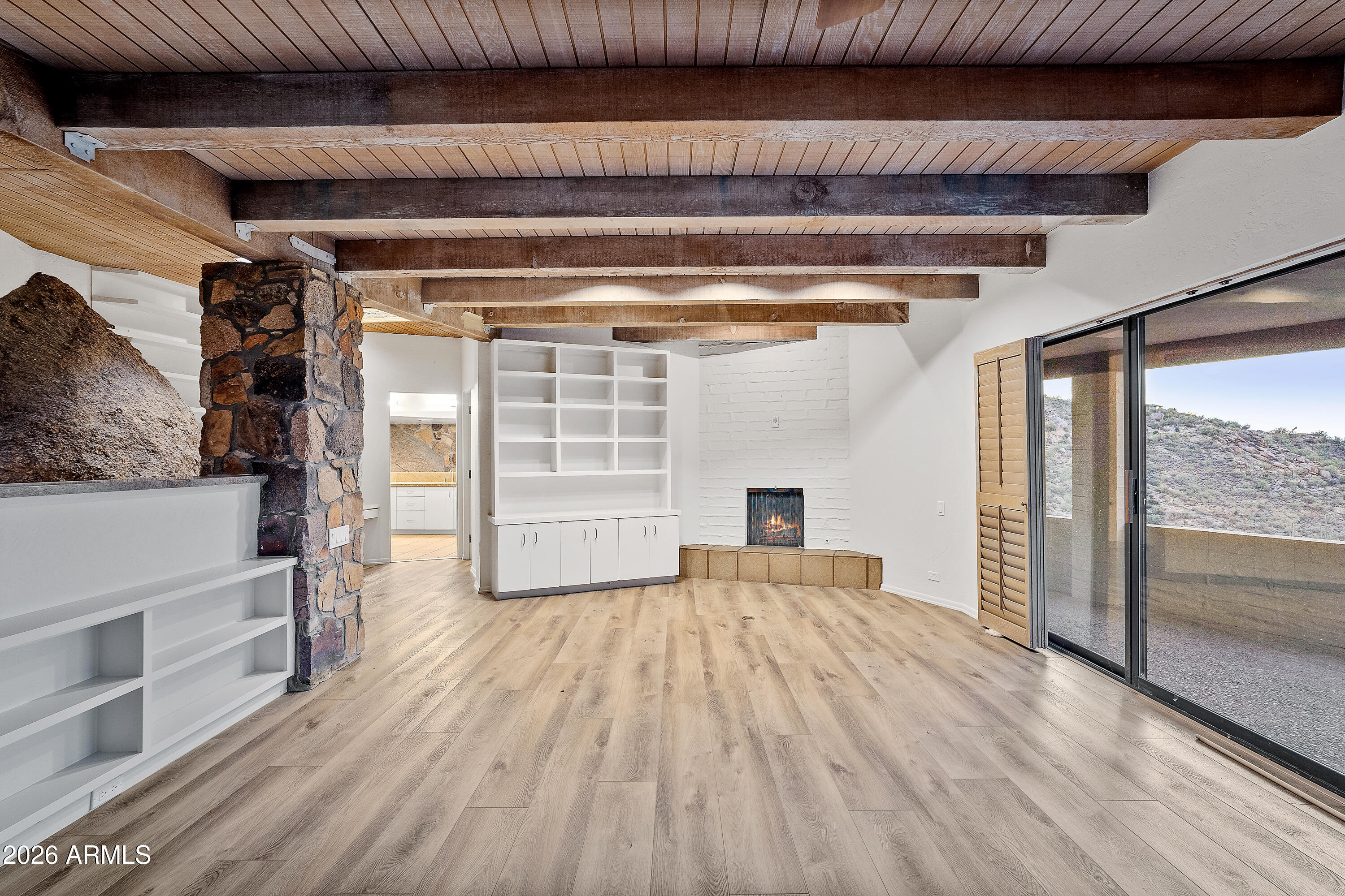 6700 East Hawksnest Road Carefree, AZ 85377 - Photo 27 of 82 a view of empty room with wooden floor and fan