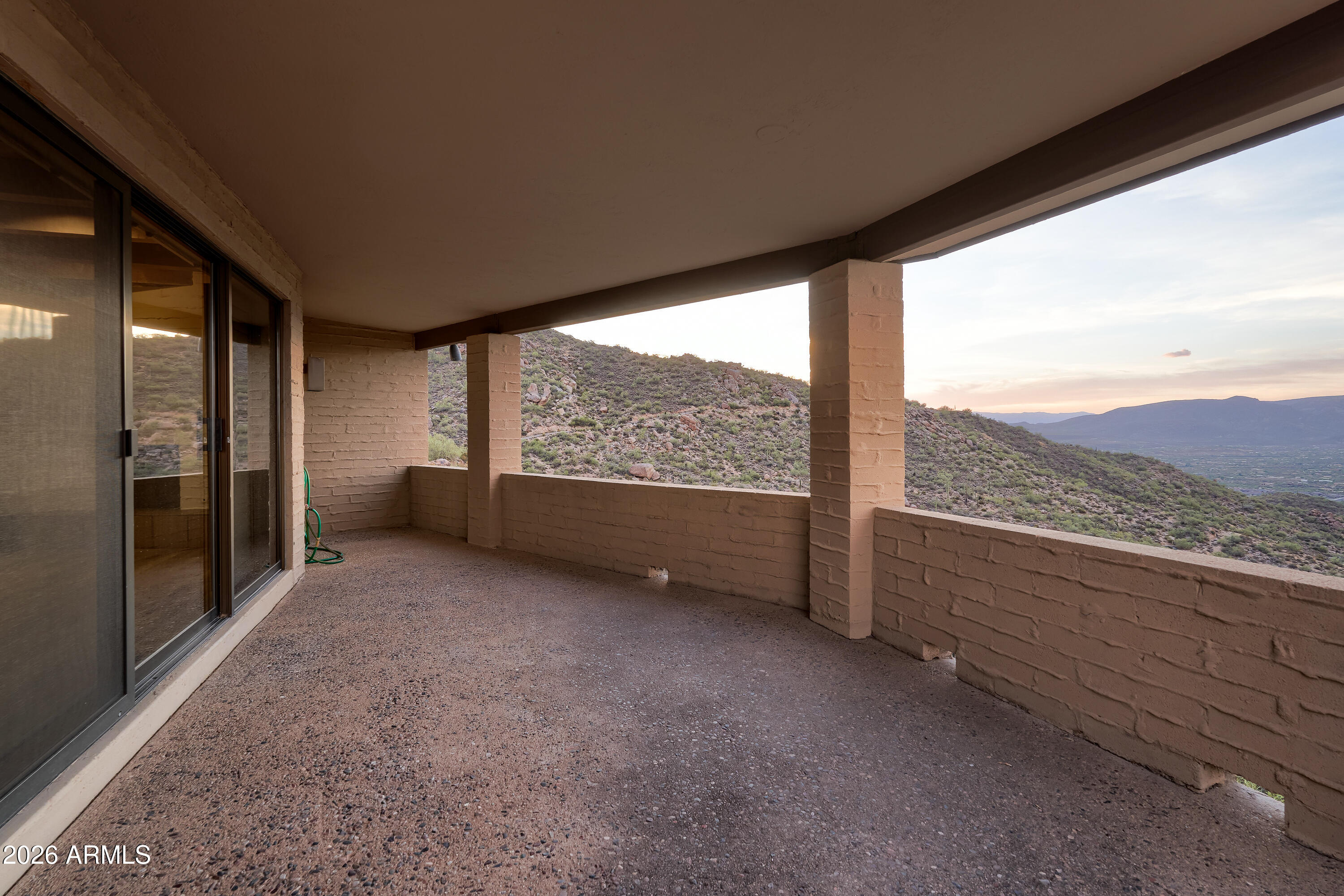 6700 East Hawksnest Road Carefree, AZ 85377 - Photo 33 of 82 a view of an empty room with a large window and kitchen view