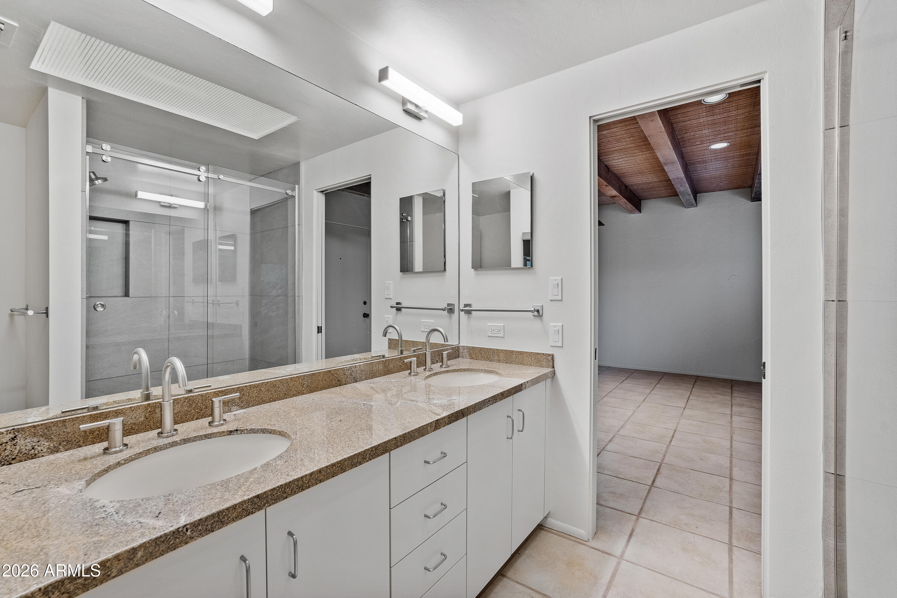 6700 East Hawksnest Road Carefree, AZ 85377 - Photo 48 of 82 a bathroom with a granite countertop sink a toilet and mirror