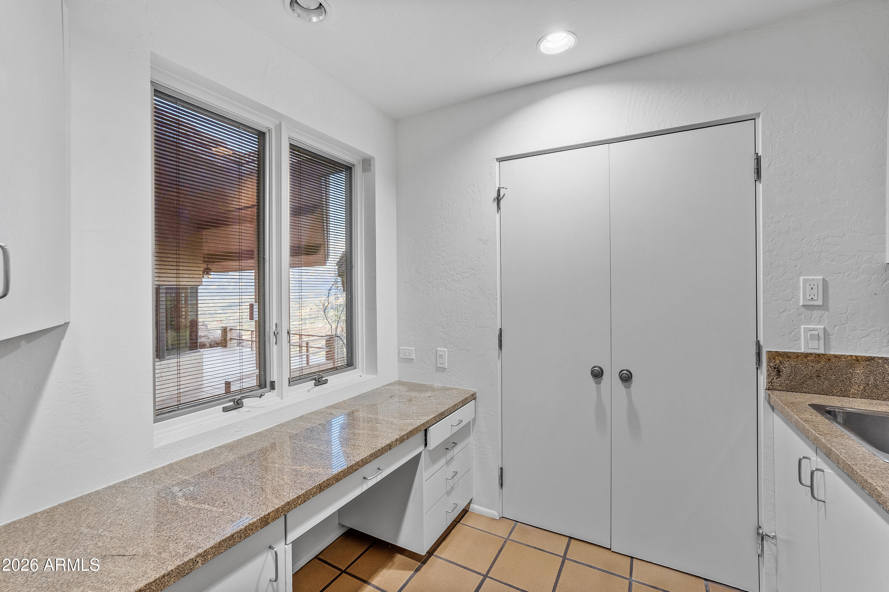 6700 East Hawksnest Road Carefree, AZ 85377 - Photo 50 of 82 a bathroom with a granite countertop sink a mirror and a shower