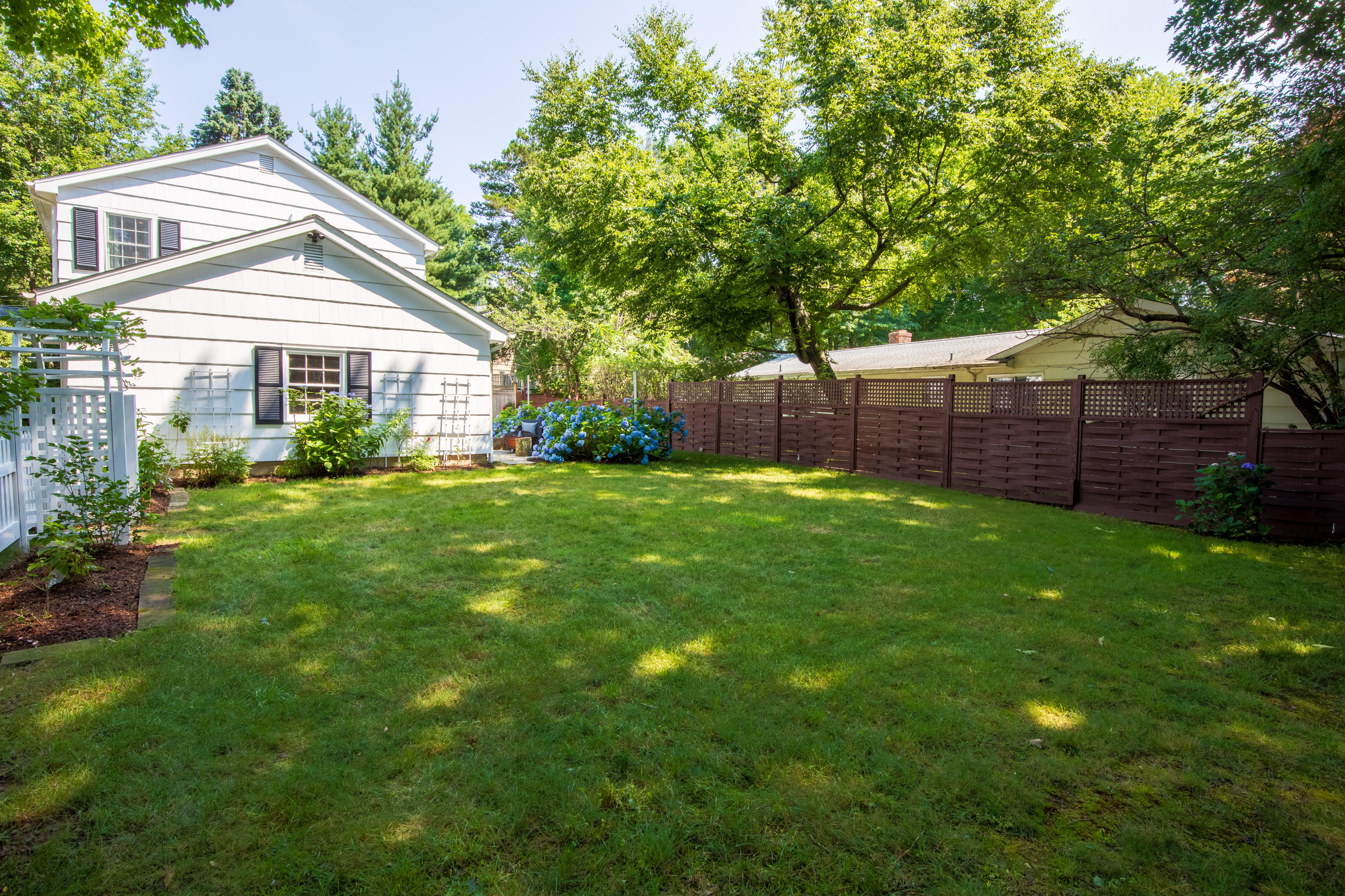 10 Old Field Road Norwalk, CT 06853 - Photo 18 of 21 a view of a yard in front of a house with plants and large tree
