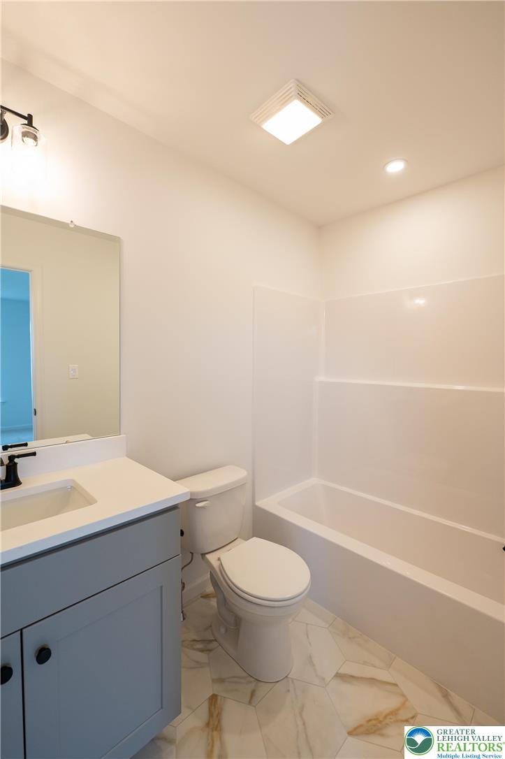 560 Long Street, Unit 1 Emmaus, PA 18049 - Photo 9 of 11 a bathroom with a toilet a sink and a bathtub