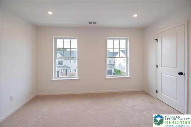 a bathroom with a granite countertop sink a toilet a mirror and bathtub
