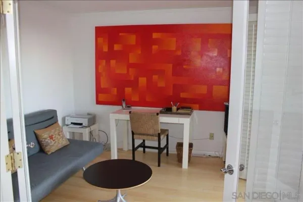 a living room with furniture and a lamp