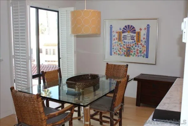 a view of a dining room with furniture and a window
