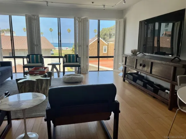 a living room with furniture and a floor to ceiling window