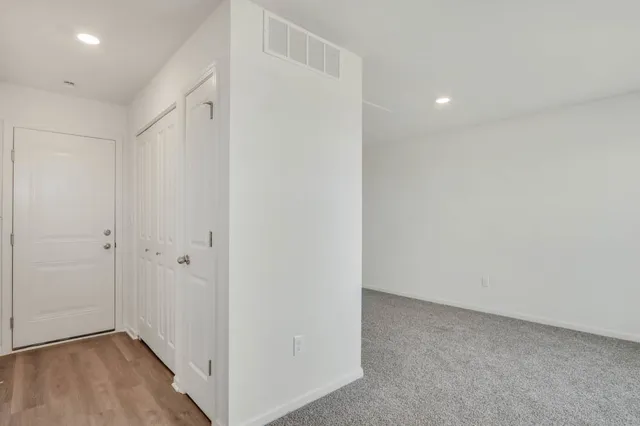 a view of hallway with wooden floor