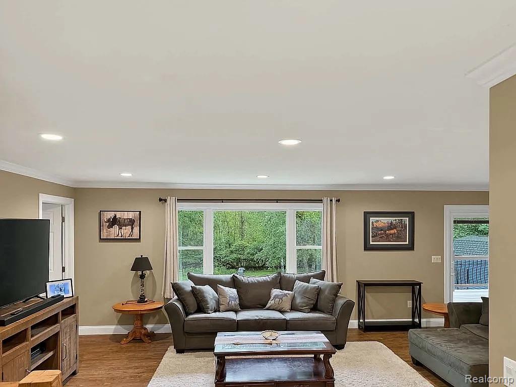 1555 Thompson Road Bad Axe, MI 48413 - Photo 3 of 14 Recessed lighting throughout, wood-finish flooring, broad window with natural light, neutral wall colors, and white crown molding