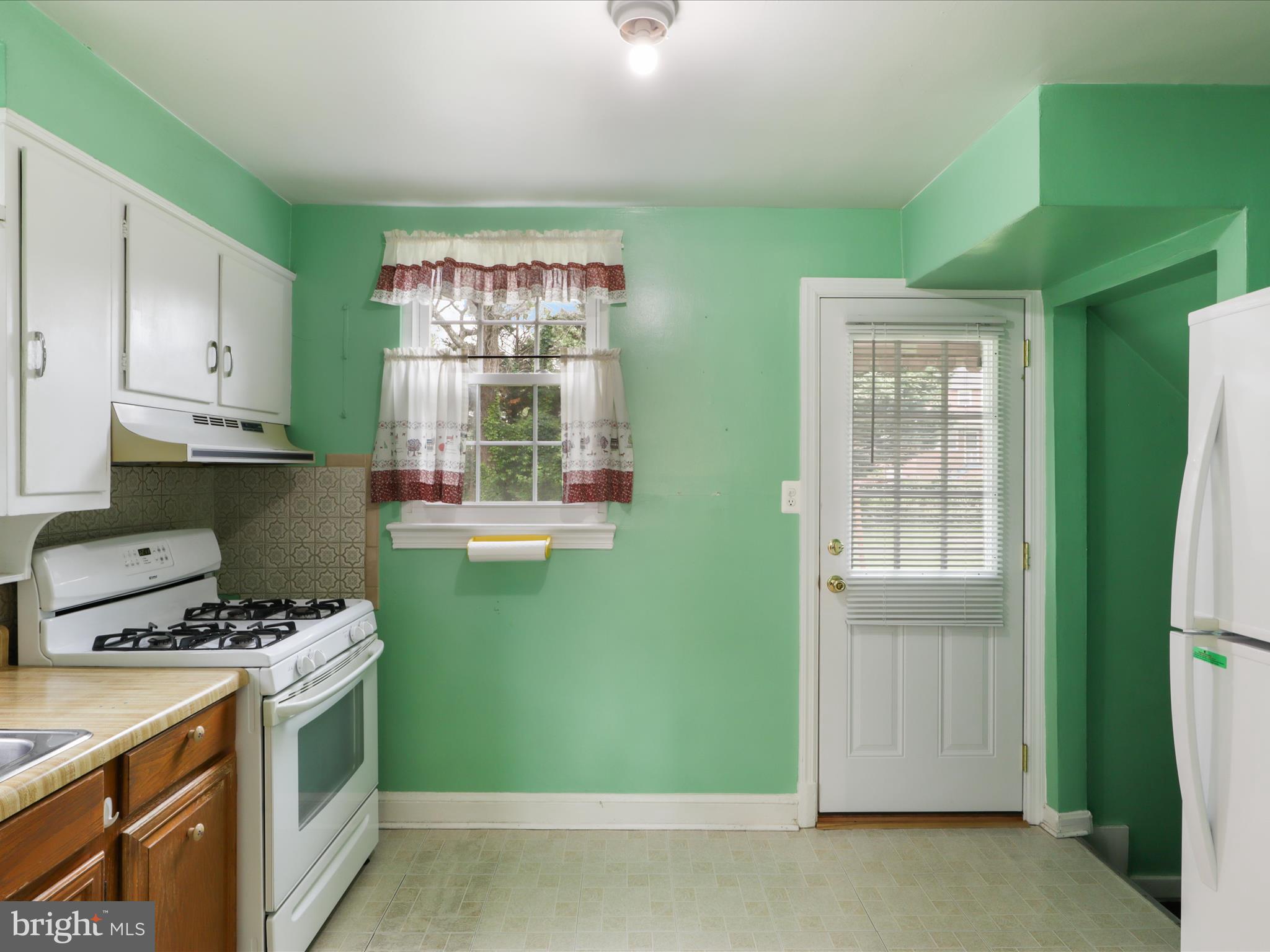 1808 Cody Drive Silver Spring, MD 20902 - Photo 11 of 41 a kitchen with a refrigerator and a stove