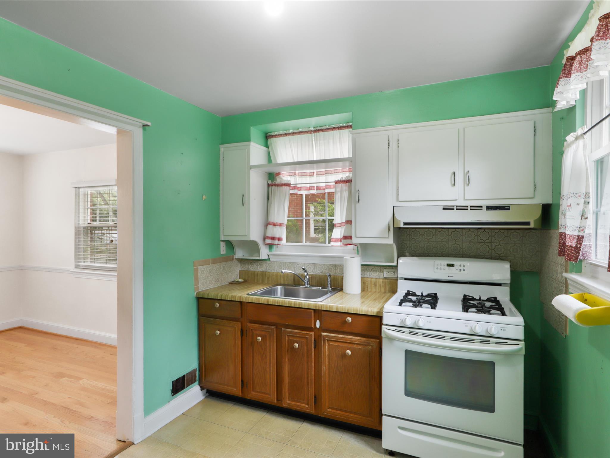 1808 Cody Drive Silver Spring, MD 20902 - Photo 12 of 41 a kitchen with a stove and a sink