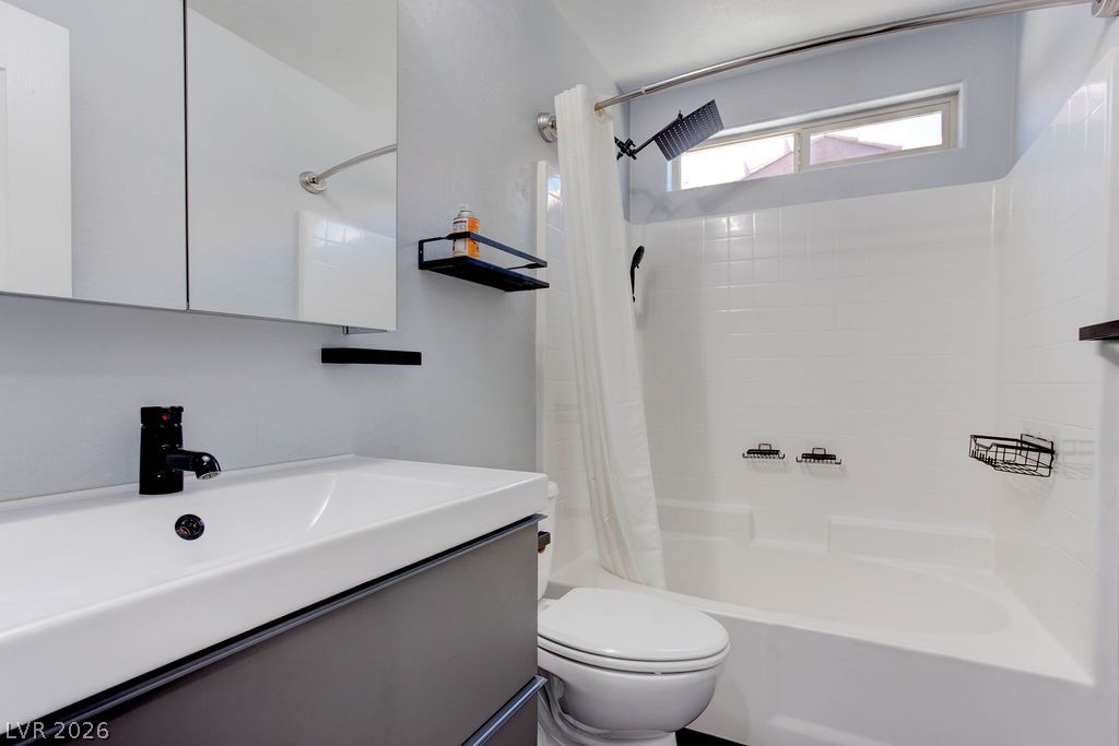 7724 Vibrant Thread Court Las Vegas, NV 89149 - Photo 26 of 43 A well-appointed bathroom offers contemporary fixtures and a pristine shower-tub combination with overhead window for natural illumination.