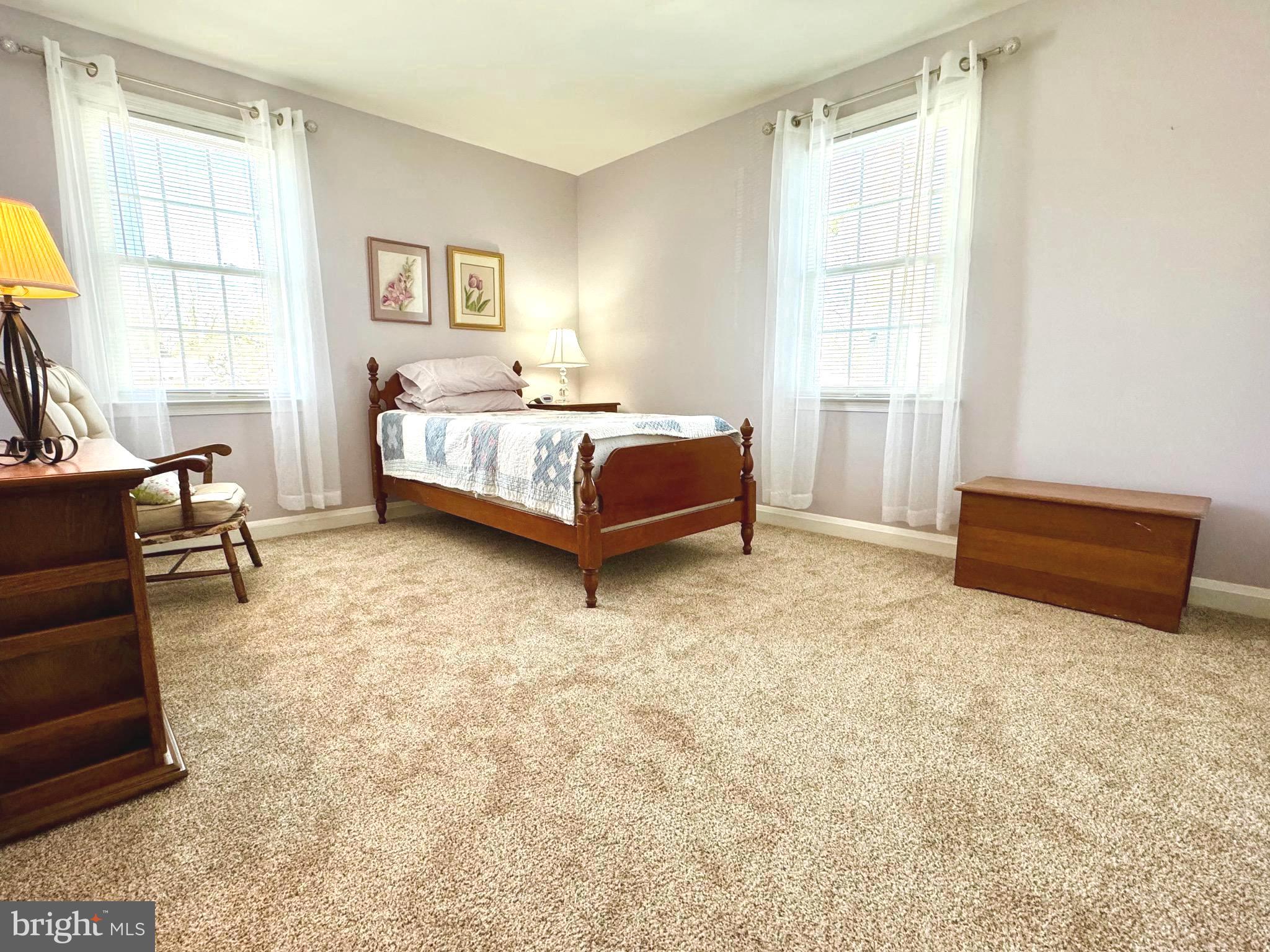 500 Milford Mill Road Pikesville, MD 21208 - Photo 18 of 43 a spacious bedroom with a bed and window