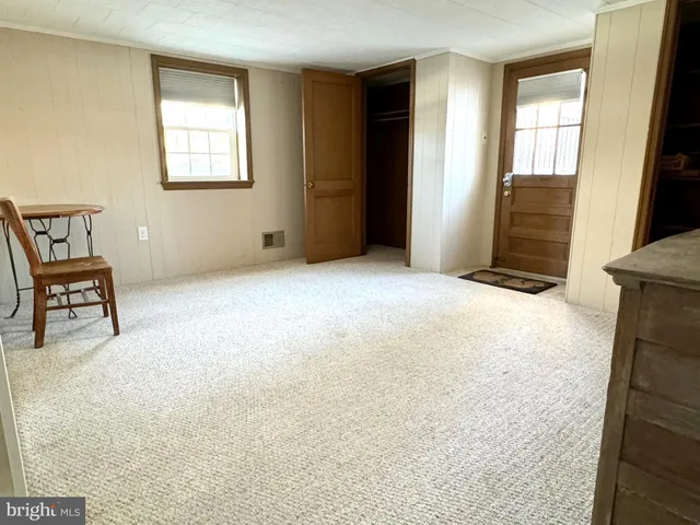 a kitchen with white cabinets and wooden floor