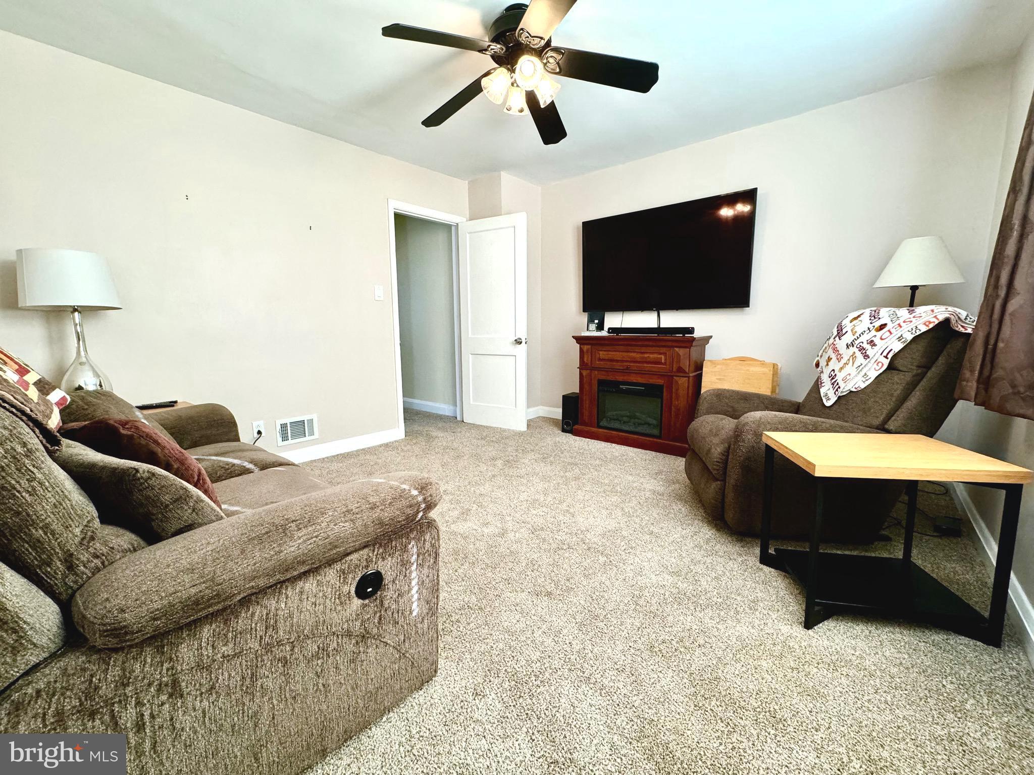 500 Milford Mill Road Pikesville, MD 21208 - Photo 9 of 43 a living room with furniture and a flat screen tv