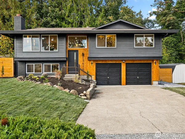 a front view of a house with a yard and garage
