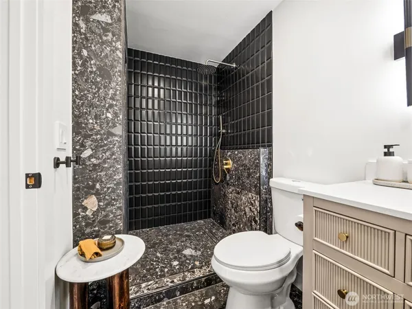 a bathroom with a sink toilet and shower