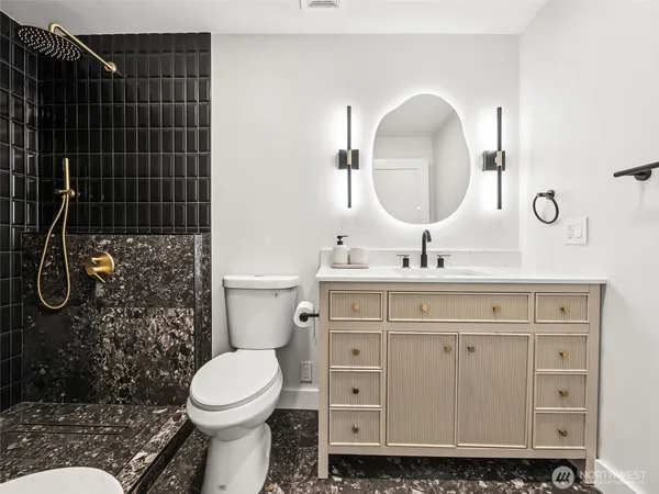 a bathroom with a sink toilet and shower