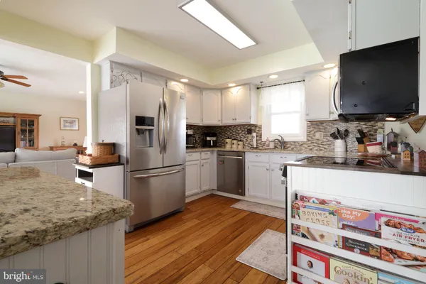 a kitchen with stainless steel appliances a refrigerator sink and cabinets