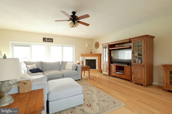 a bathroom with a granite countertop sink a toilet and a mirror