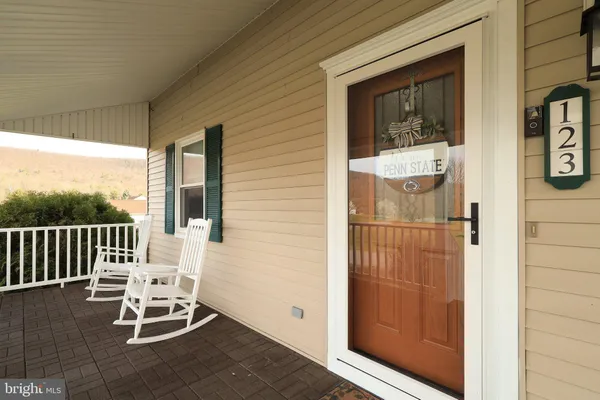 a kitchen with a refrigerator a sink and wooden floor