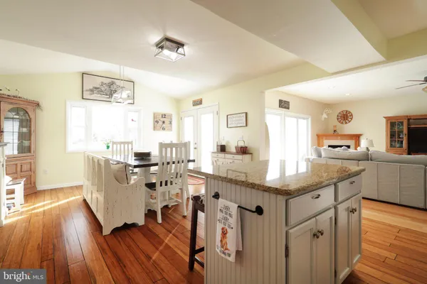 a kitchen with granite countertop a stove top oven microwave and cabinets